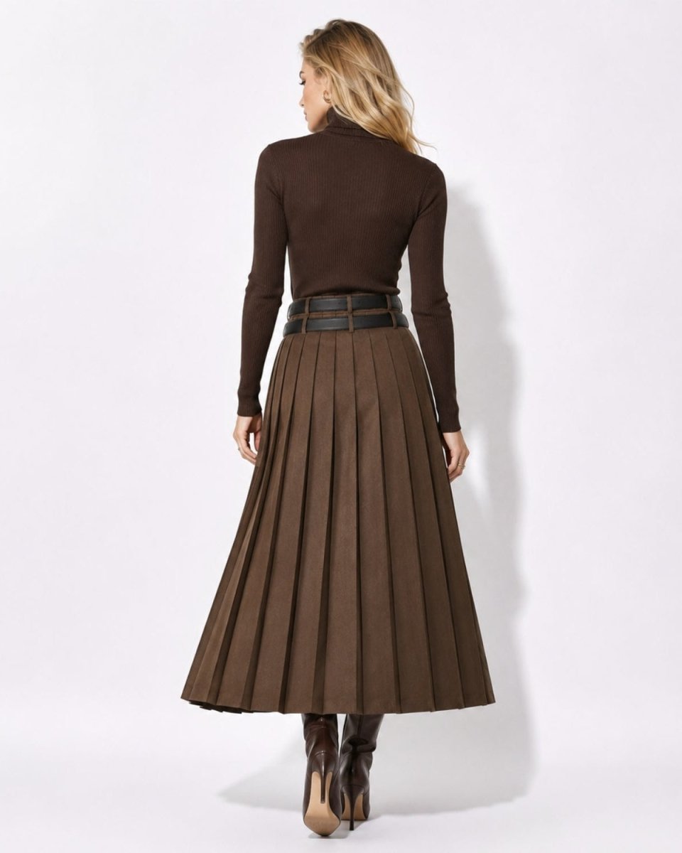 A woman shown from the back wearing a dark brown mock-neck long-sleeve turtleneck sweater and a matching dark brown pleated midi skirt with a wide dark belt, paired with brown boots, against a plain white studio background.