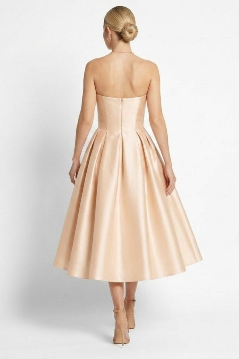 Back view of strapless formal evening dress showing invisible zipper, tailored bodice, and elegant updo