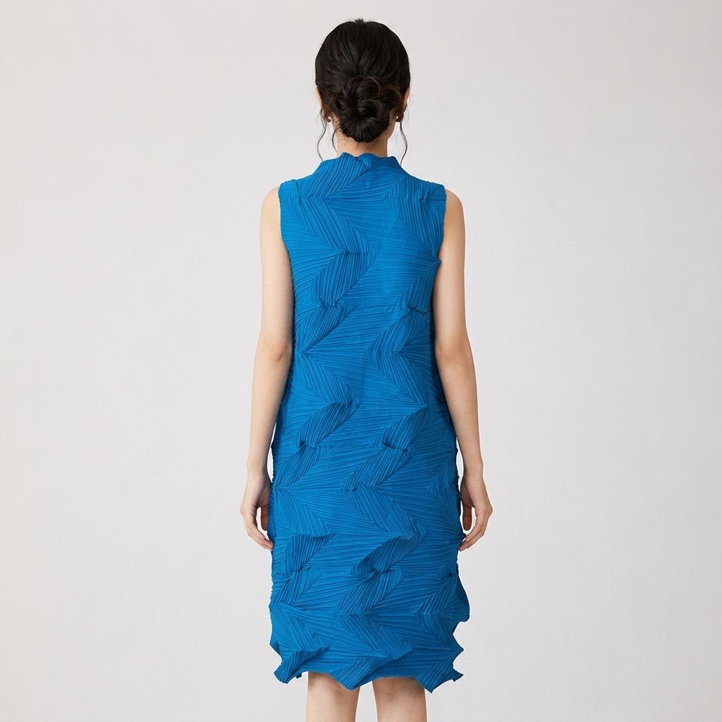 Back view of female model showcasing the hidden zipper and geometric texture of the blue pleated mock neck midi dress.