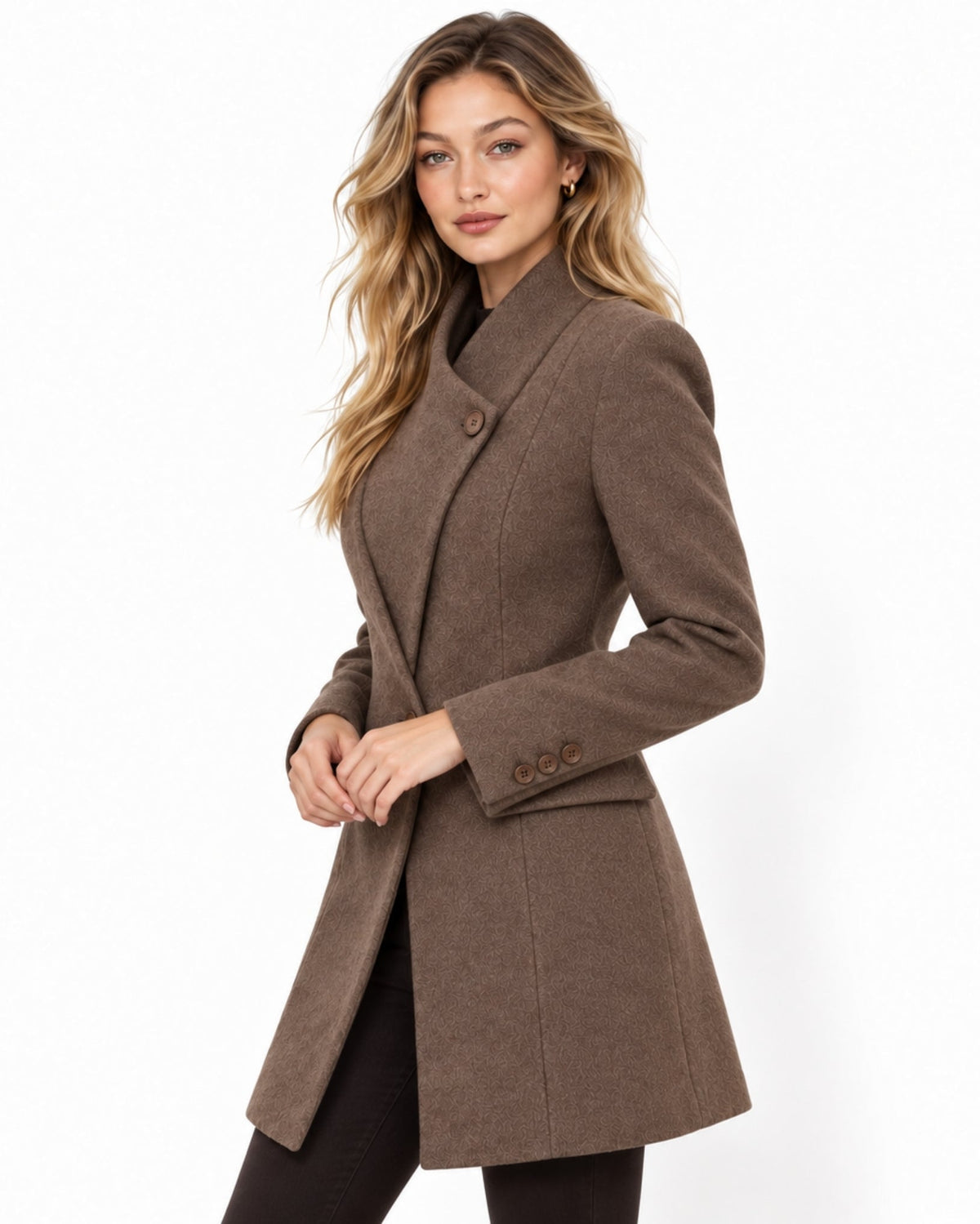 A woman modeling a brown double-breasted wrap coat with structured shoulders and three-quarter sleeves, photographed against a clean white studio background.