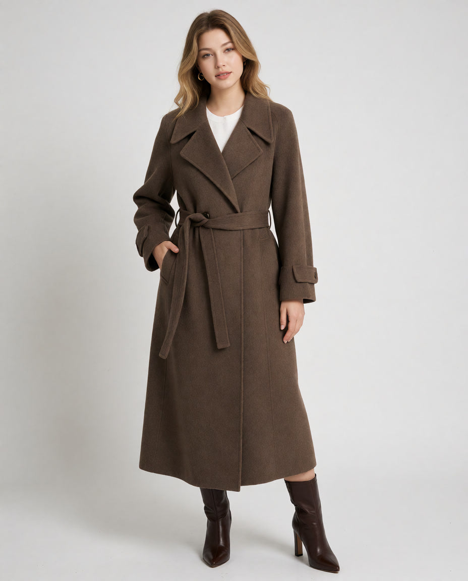 Front view of a woman wearing a long coffee wrap coat with a tied waist belt and oversized lapels