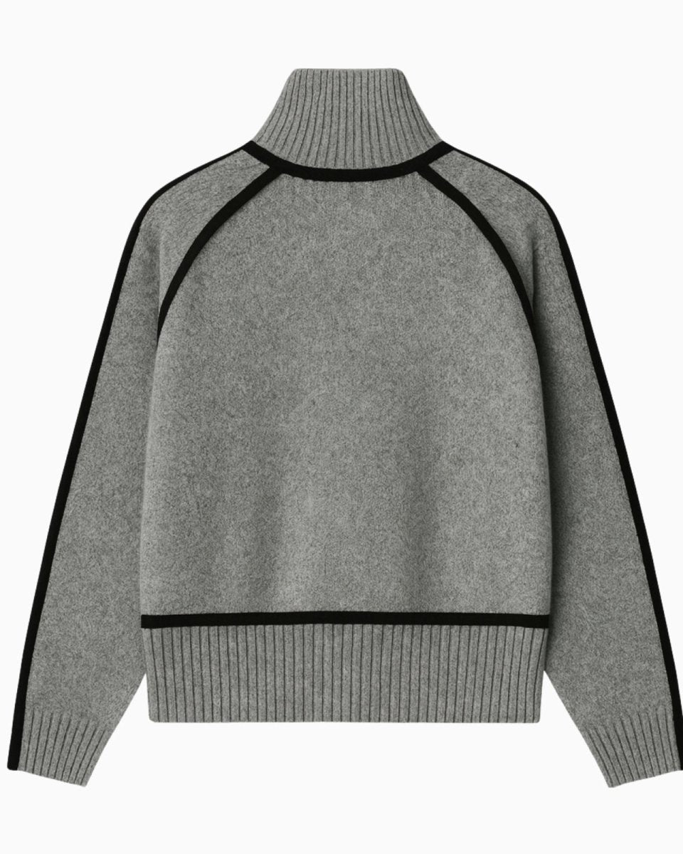 Product flatlay showing the back of a gray cashmere blend sweater with black piping along the raglan sleeves.