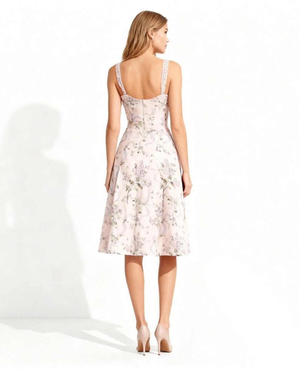 Back view of the pink floral dress highlighting the smocked back panel and delicate lace shoulder.