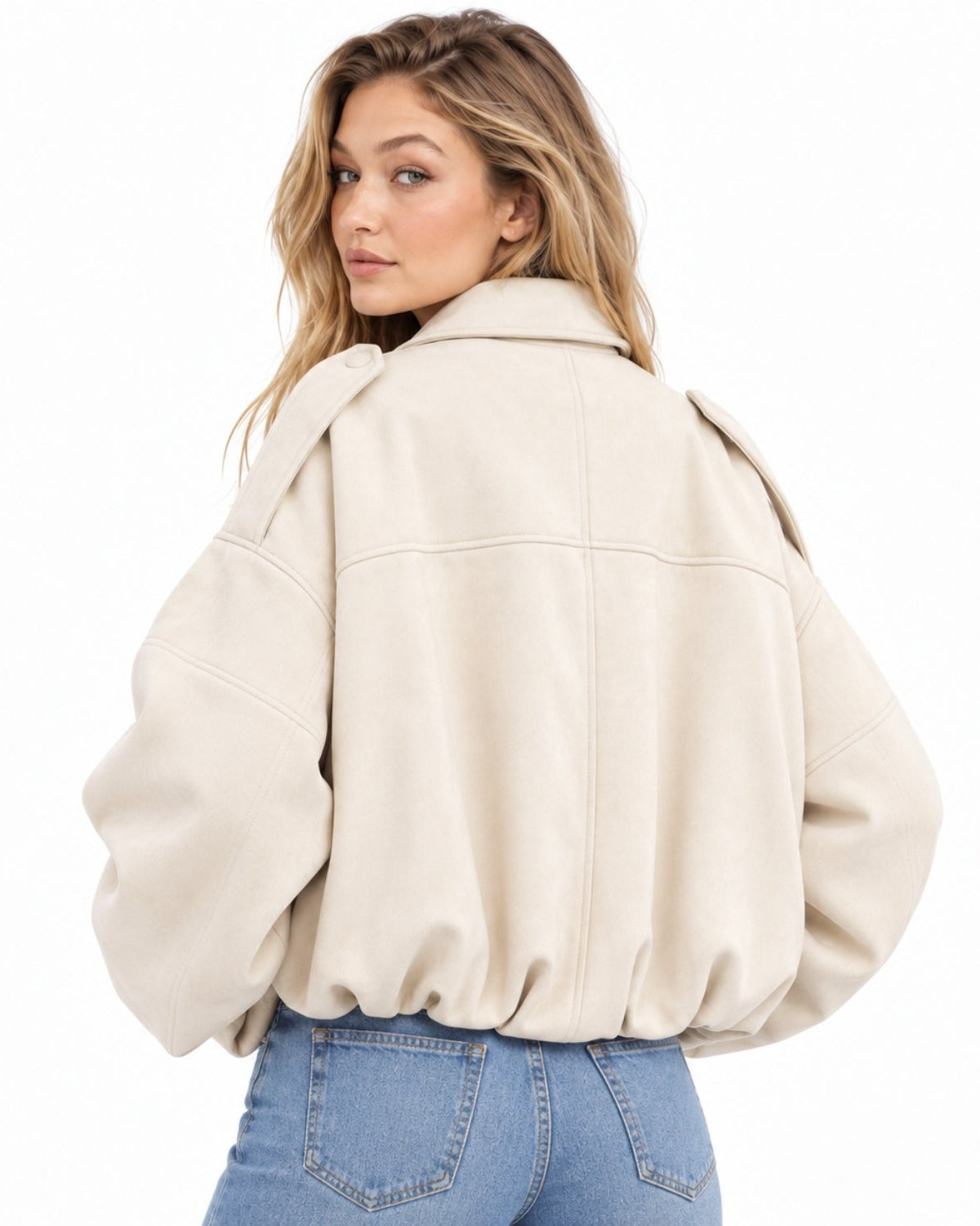 A woman wearing an oversized cream-colored faux leather jacket, shown from the back against a solid white background.