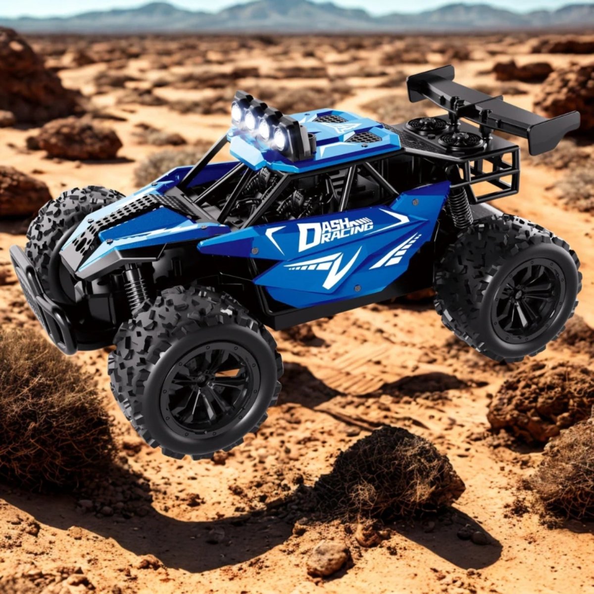 A blue high-speed off-road RC racing buggy captured in mid-air during a jump over a sandy desert landscape.