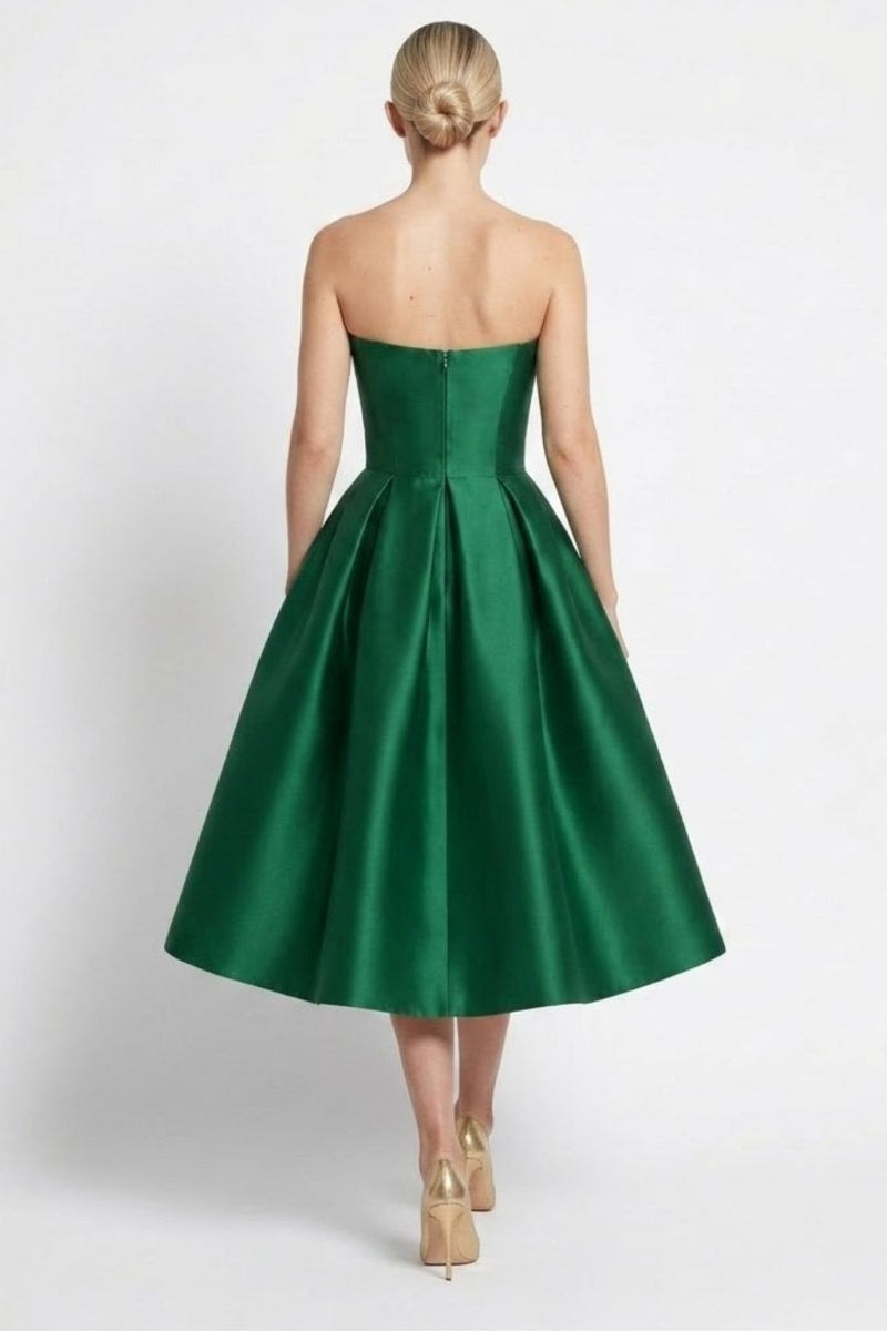 Back view of the dark green satin evening dress highlighting the invisible zipper closure and structured flared midi hem.