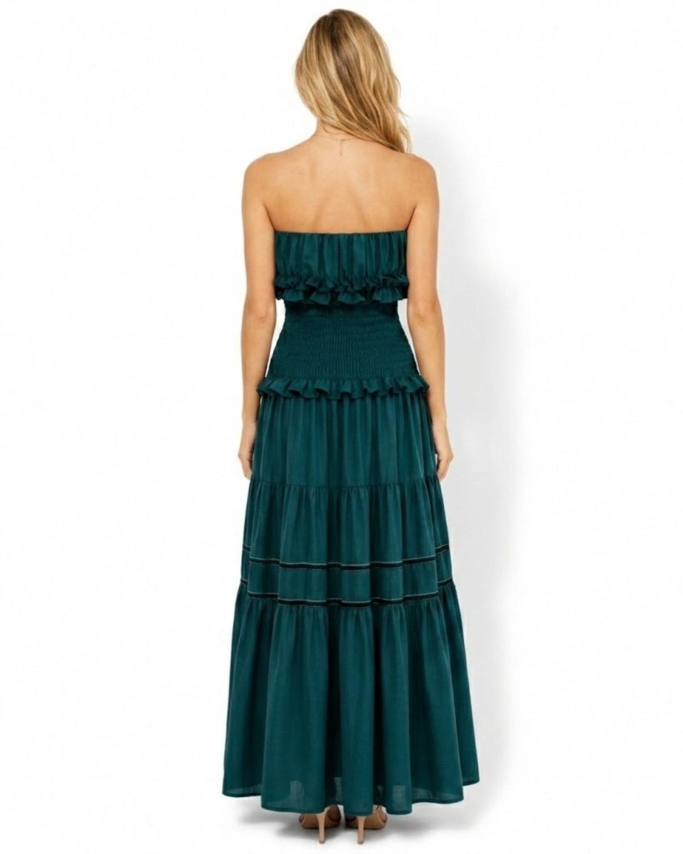 Back view of green strapless resort wear dress highlighting the secure stretchy smocked back and long elegant skirt.
