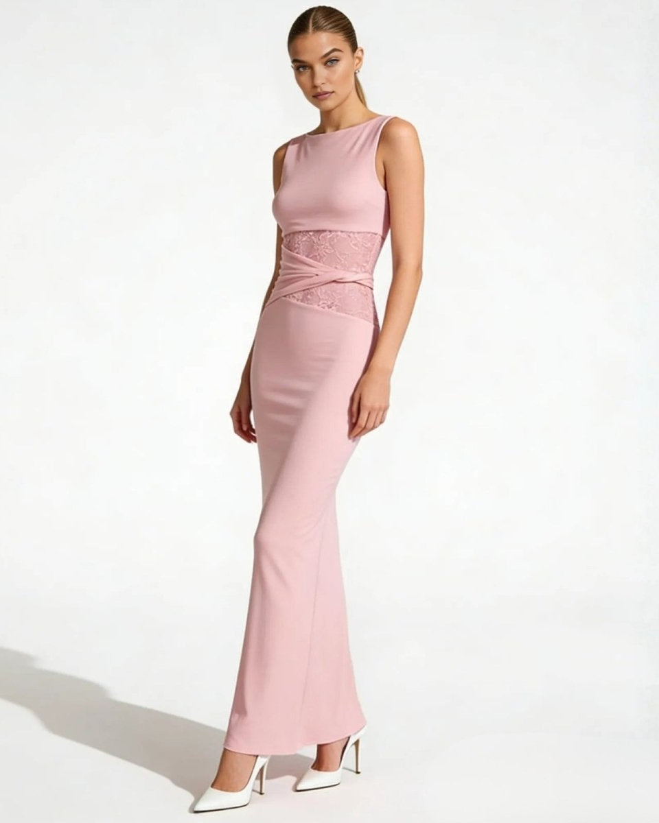 Angled view of a woman in the deborah pink column gown, highlighting the figure-flattering silhouette and lace side panel.
