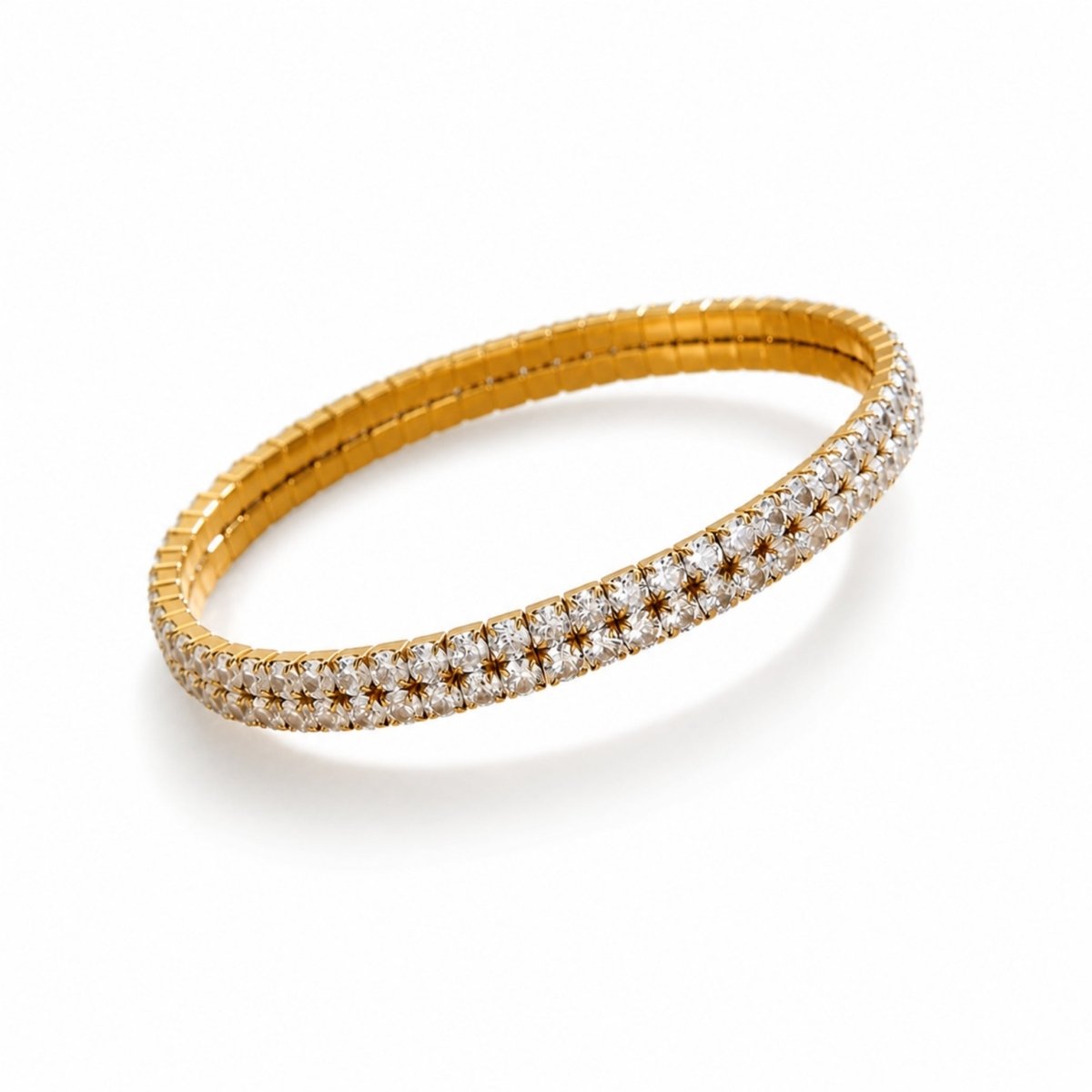 Isolated studio view of the Kouvr double row gold stretch tennis bracelet featuring brilliant cut cubic zirconia stones on a pure white background.