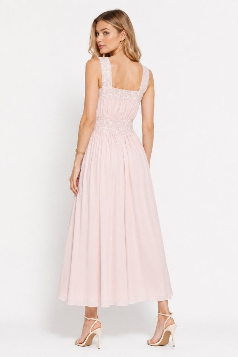 Back view of romantic blush pink garden party dress with wide lace straps and fluid A-line skirt