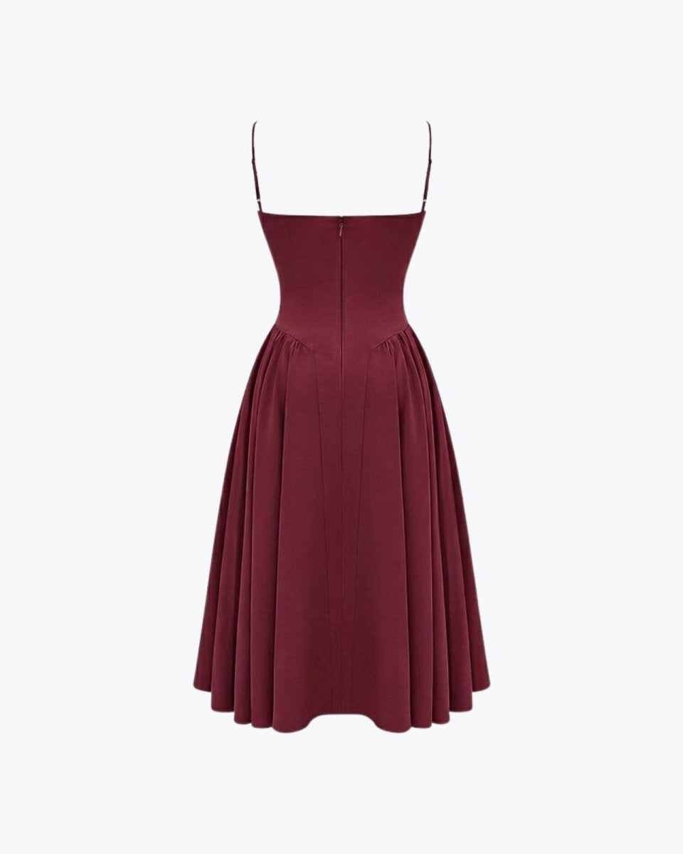 Rear product image of the Evdokia dress in burgundy, detailing the back zipper and pleated skirt construction.