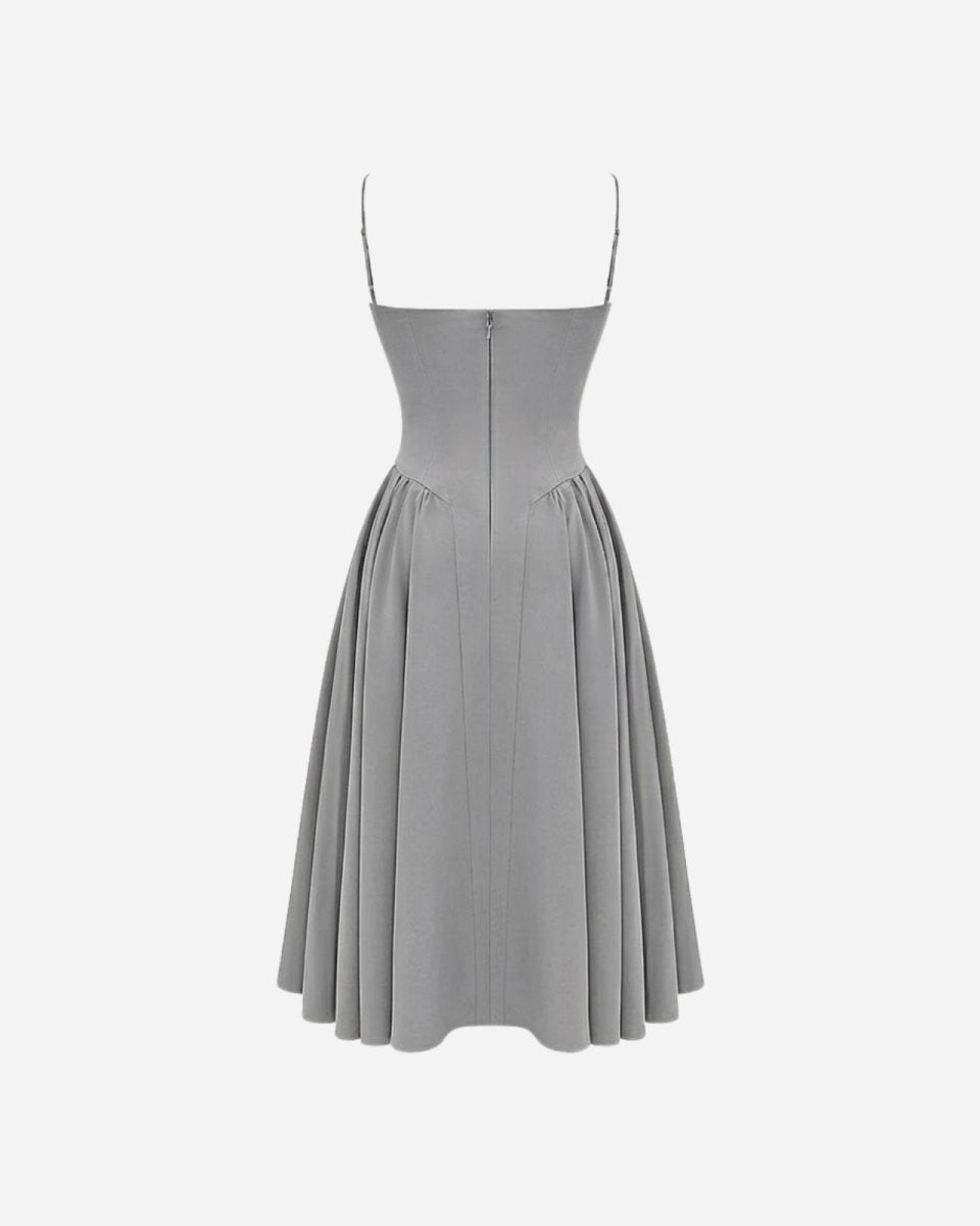 Rear product shot of the Evdokia grey dress, highlighting the pleated skirt and zipper construction.