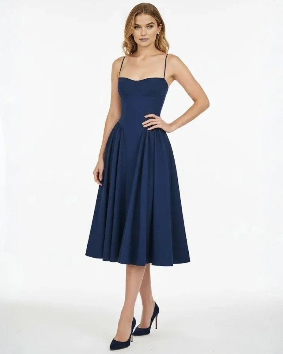 Model wearing the Evdokia navy corset midi dress from, showing the structured sweetheart bodice and full pleated skirt from the front.