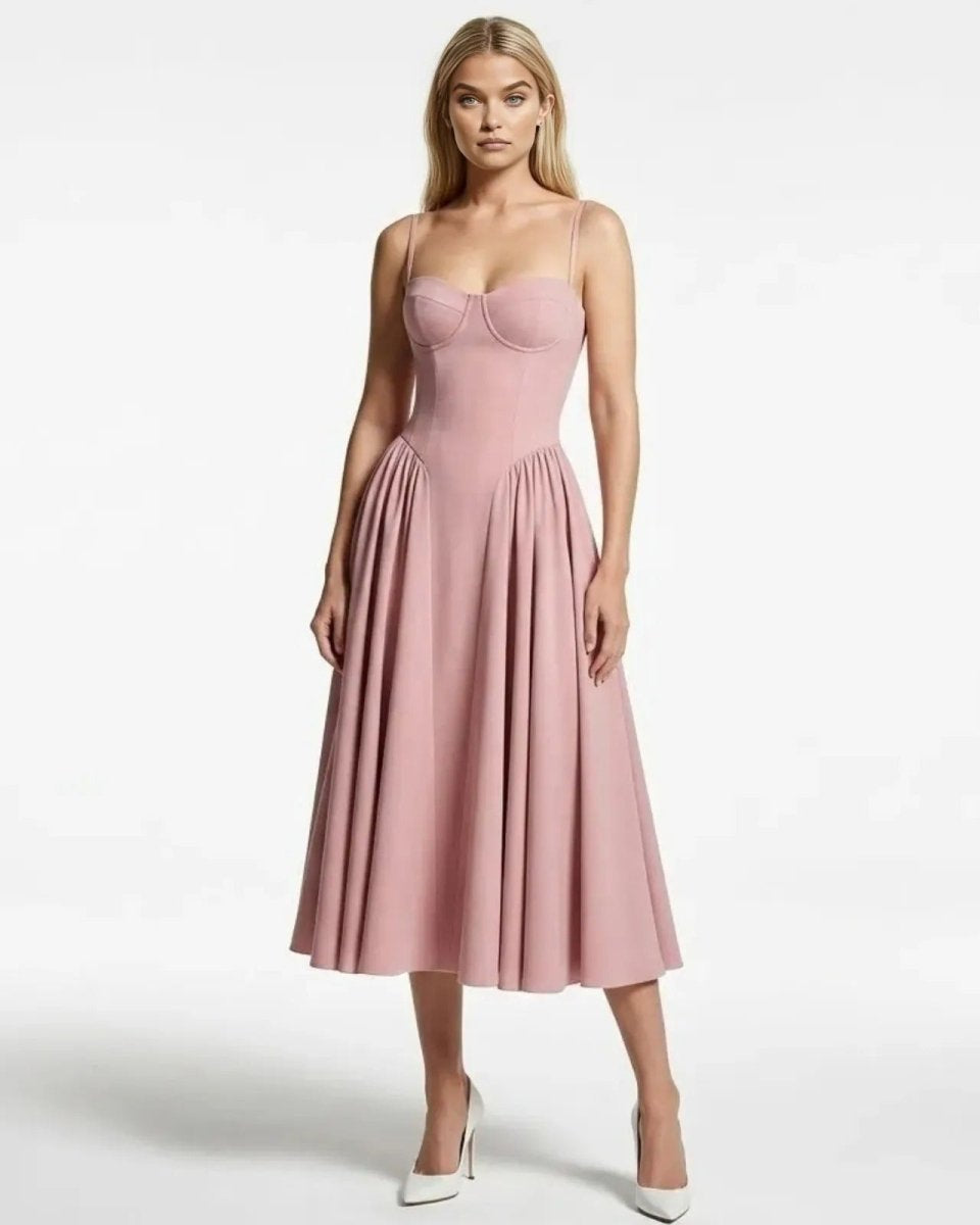 Model wearing the Evdokia pink bustier midi dress with a structured corset bodice and full A-line pleated skirt, front view.