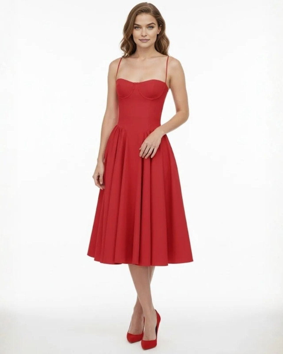 Model wearing the Evdokia scarlet red bustier midi dress with a sweetheart neckline and full A-line skirt, paired with red heels.