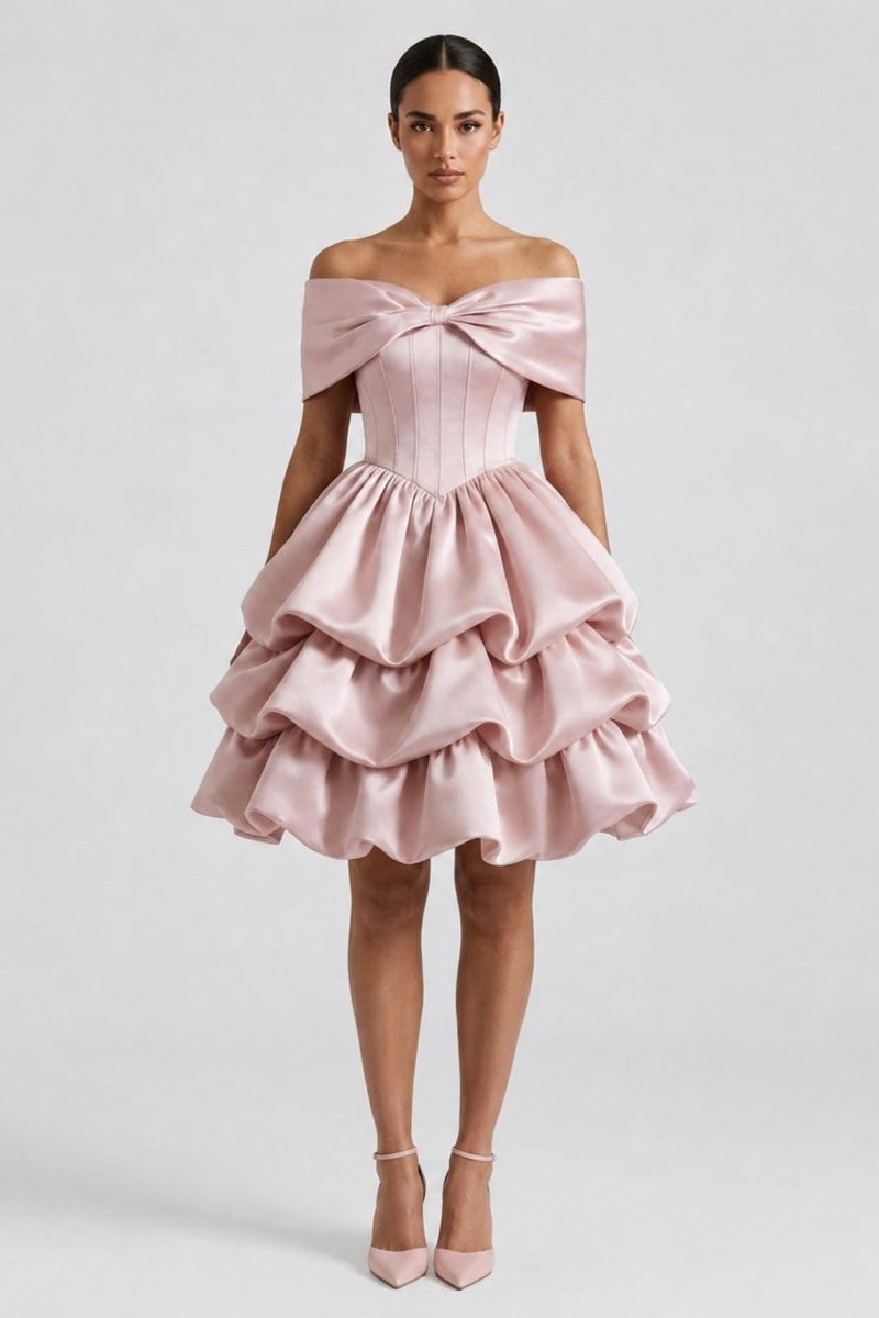 Woman wearing Fenlo form pink satin off the shoulder mini dress with corset bodice and tiered ruffle skirt, front view.