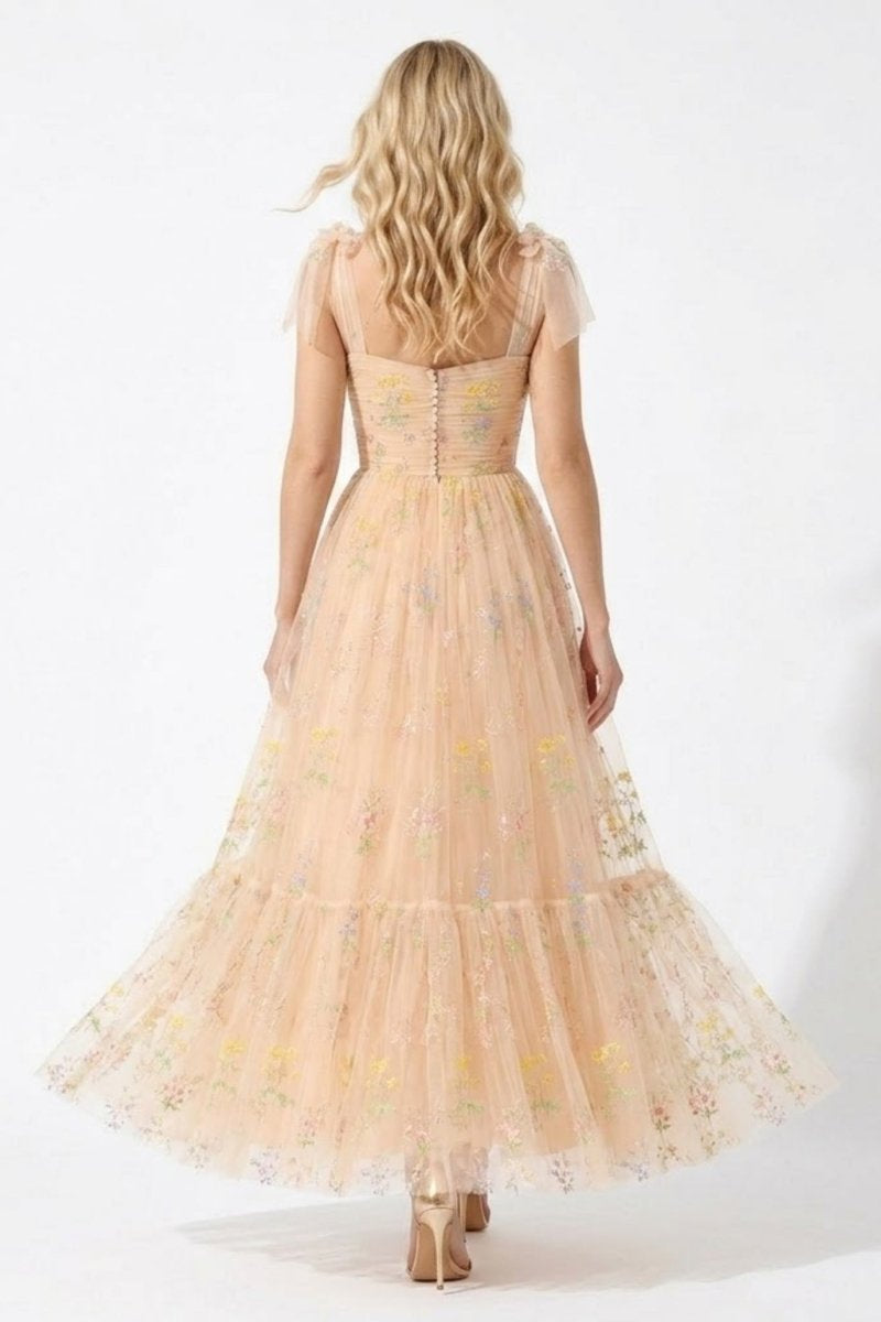 Back view of fairycore romantic tulle gown showing decorative back buttons and flowing tiered skirt.