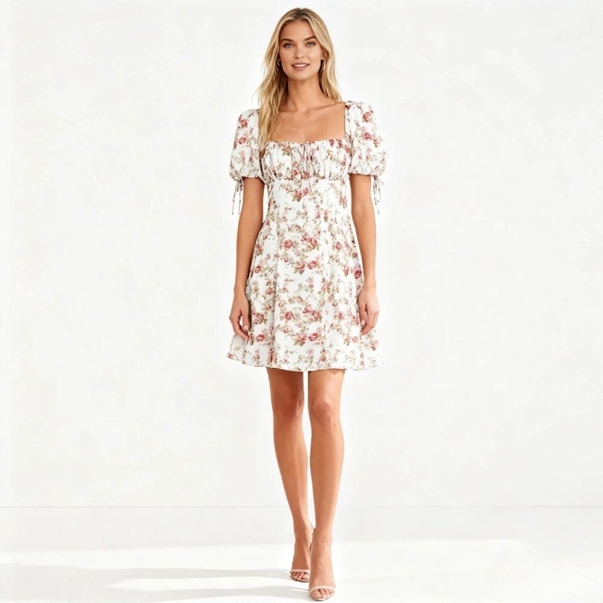 Woman wearing a floral Kouvr dress on a white background