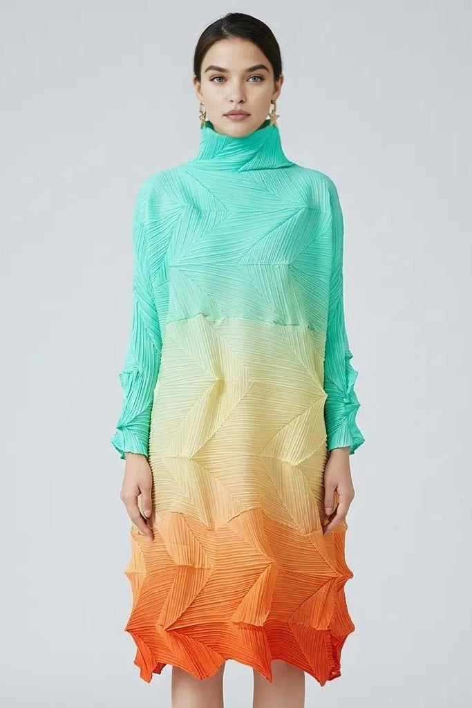 Woman wearing Fenlo Form pleated gradient dress demonstrating the flexible structure in mint green to orange, front view.