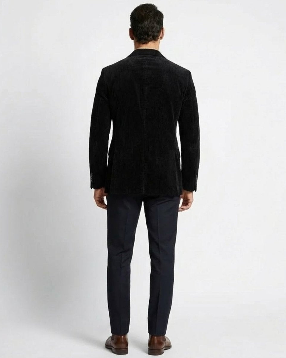 Rear view of the Grady men's black corduroy blazer, highlighting the dual-vented back and tailored silhouette.