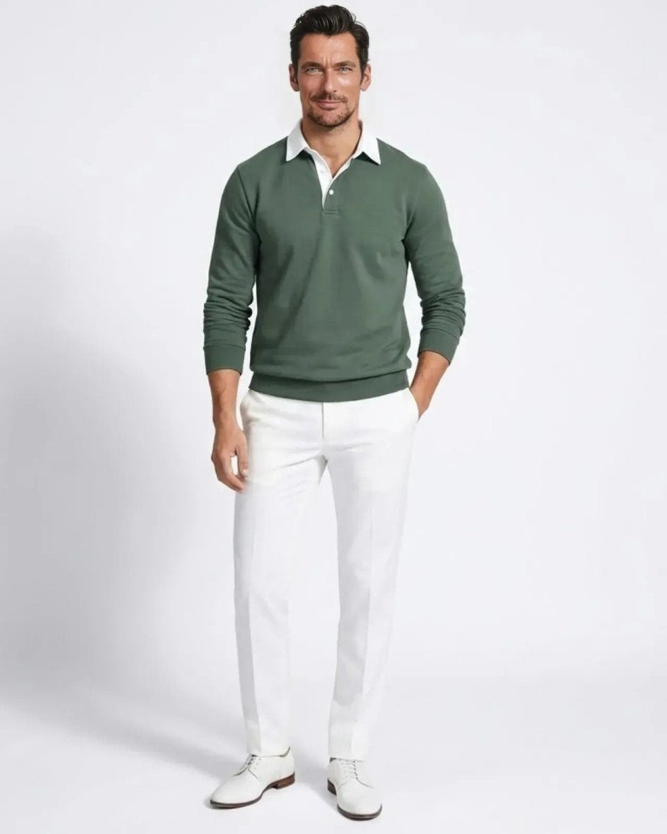 Man wearing the green long-sleeve knit polo sweater with white trousers, shown from the front.