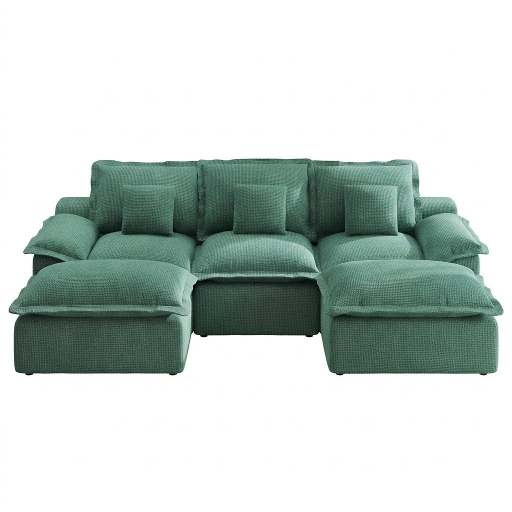 green-modular-sectional-open-concept-living.jpg Open-concept living space featuring a green modular sectional sofa, jute rug, and wooden dining table.