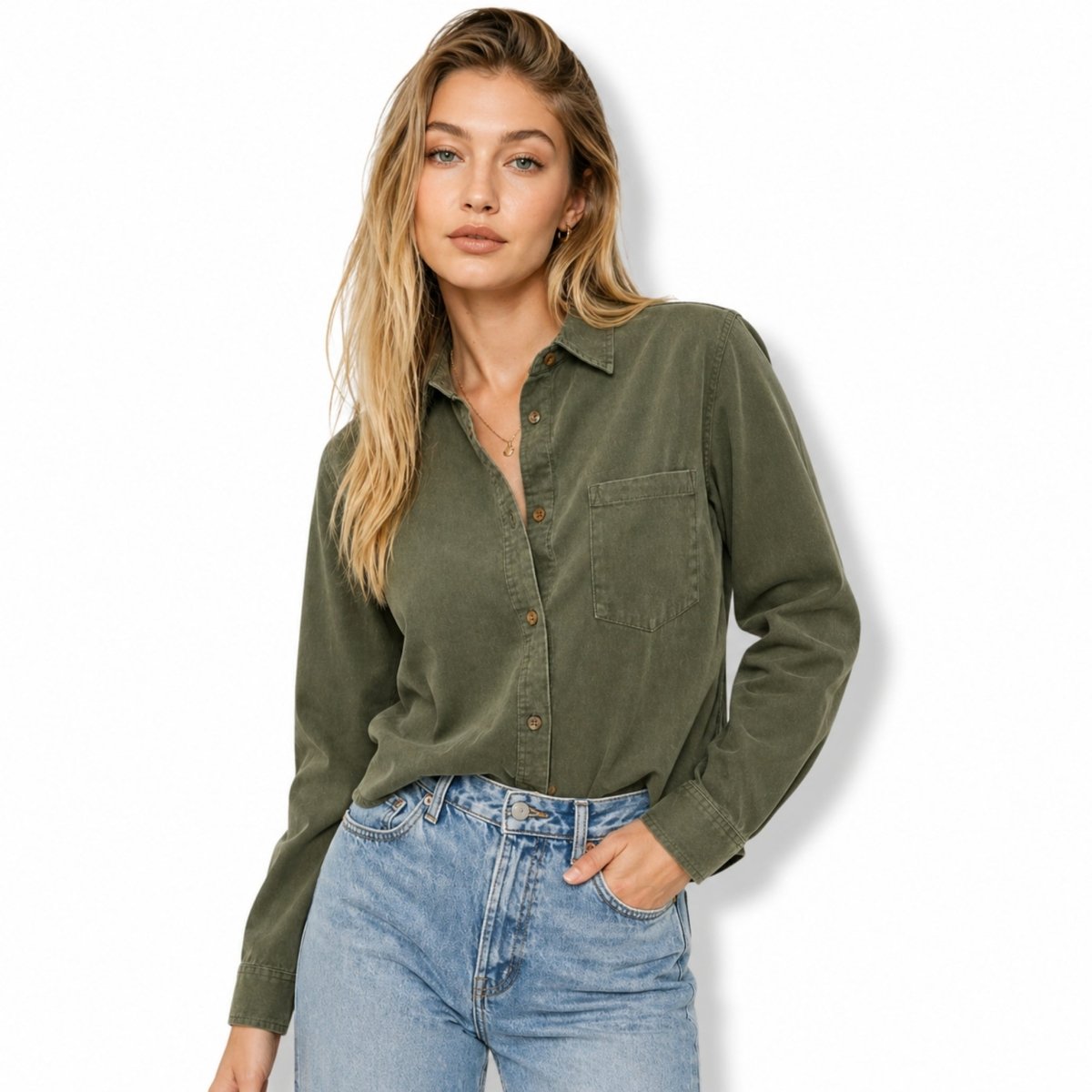 Woman wearing an green casual shacket with front chest pocket tucked into light wash jeans