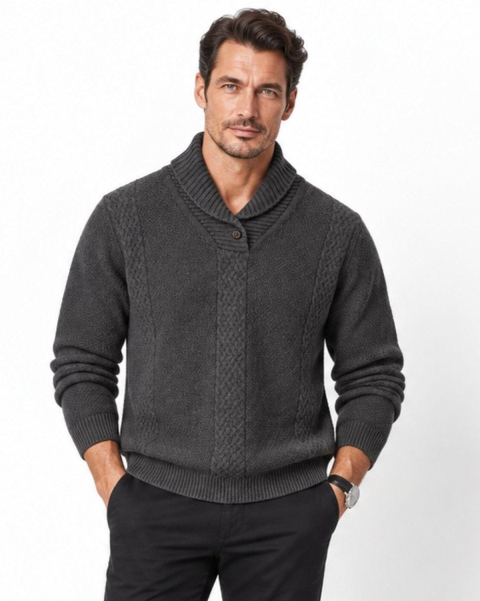 Front view of a male model wearing a luxury charcoal grey shawl collar cable knit sweater with single button detail.