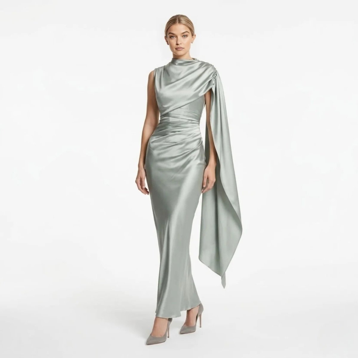 Front view of the Kouvr sage green satin asymmetrical cape maxi dress showing draped neckline and ruched waistline.
