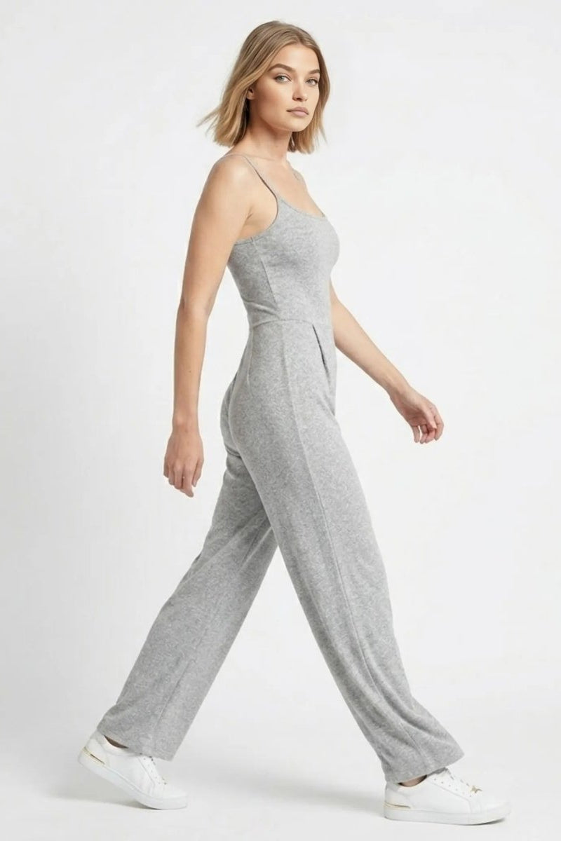 Side view of woman walking in a comfortable stretch grey wide leg lounge jumpsuit by Fenlo Form