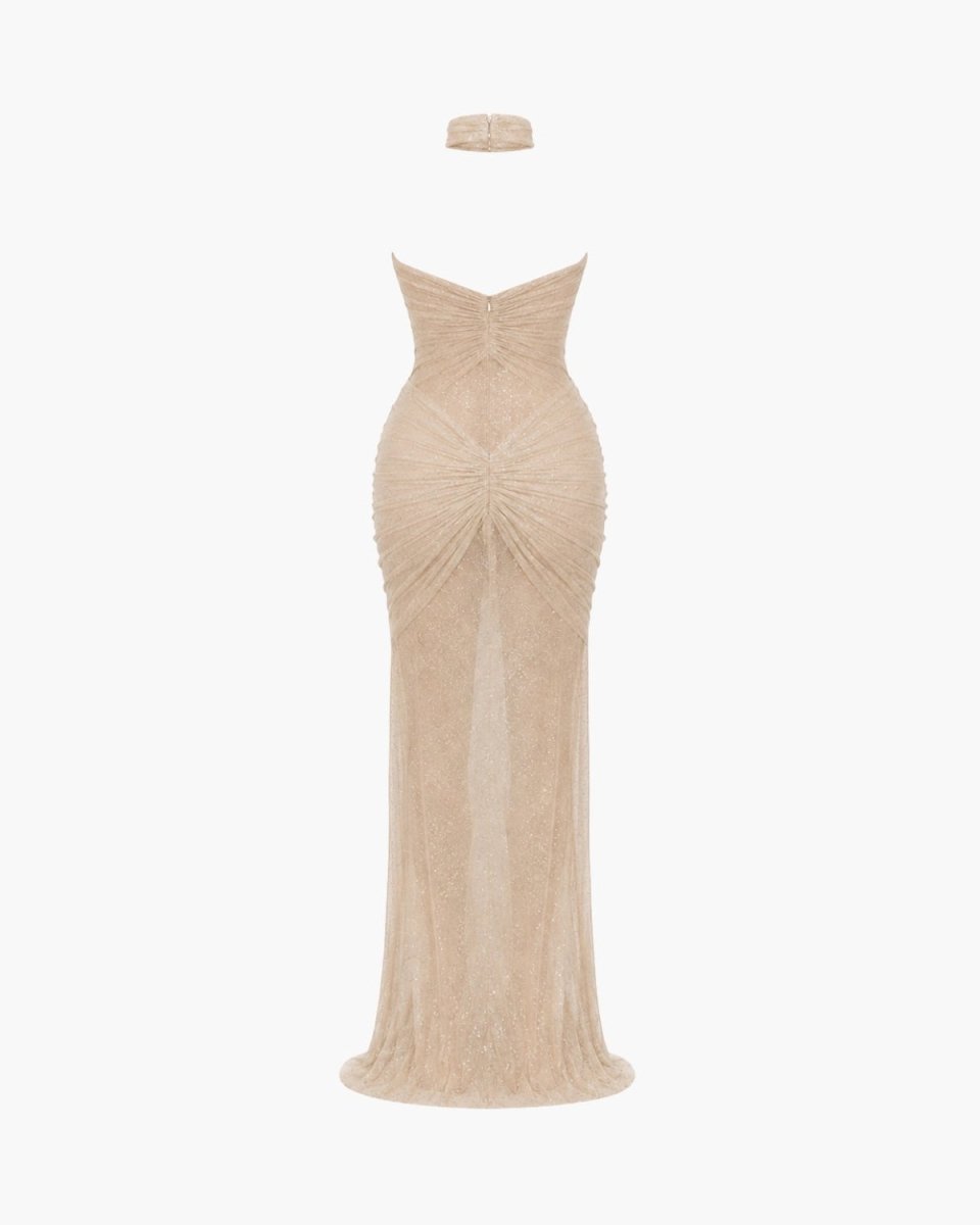 A strapless floor-length gown in a light champagne beige color, featuring a sweetheart neckline, ruched bodice, and a matching headband, shown against a plain white background.
