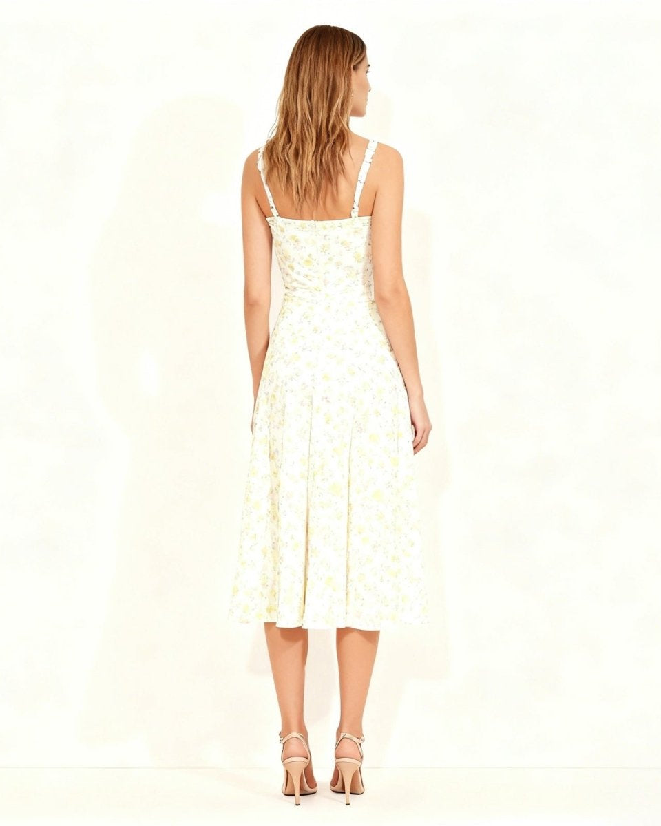 Back view of the ivory dress highlighting the smocked back panel and delicate lace shoulder straps.