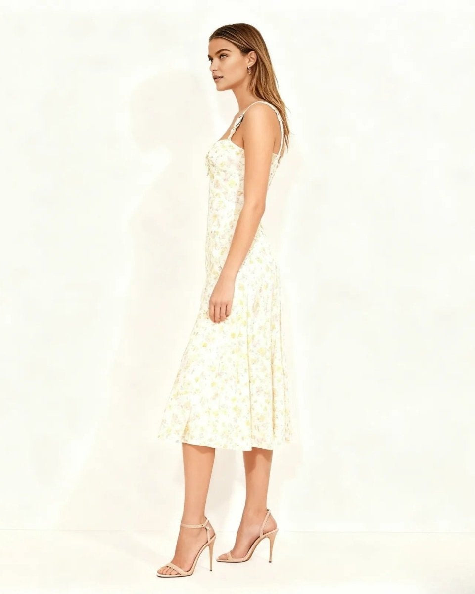 Side profile of a model in the ivory A-line midi dress, showcasing its fit and flare silhouette.