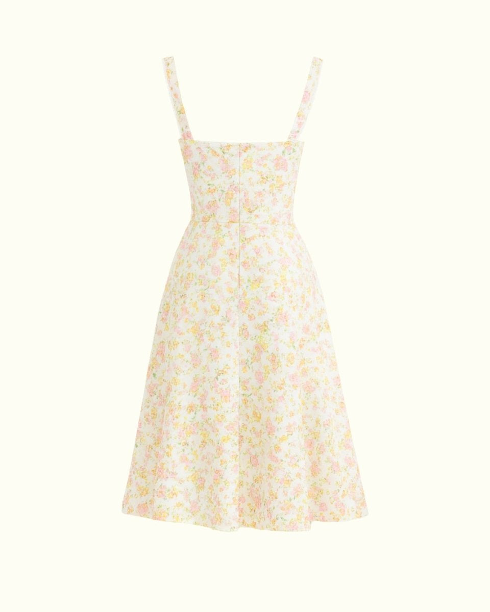 Close-up detail of the sweetheart neckline, tie-front feature, and jacquard fabric of the yellow rose floral midi dress.