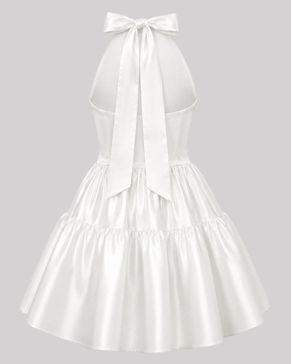 Ghost mannequin back view of a ivory party dress showing an oversized neck bow tie and center back zipper.
