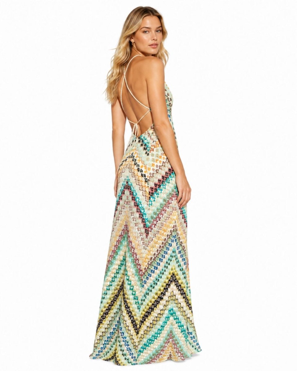 A woman modeling a sleeveless maxi dress with a colorful chevron pattern, shown from the back against a plain white background.