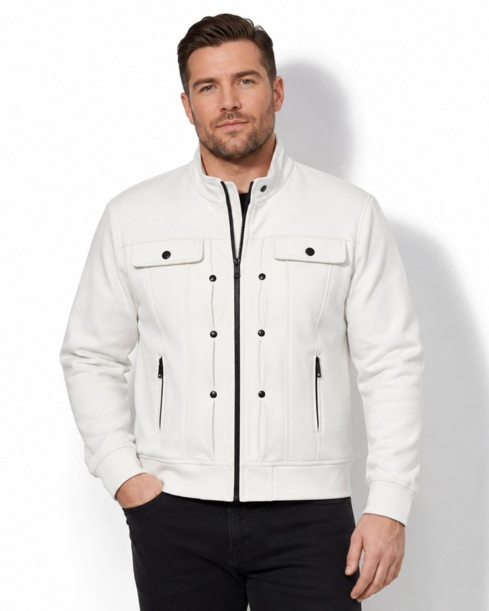 A man wearing a white zip-up jacket with black zipper details and black pants, standing against a white studio background.