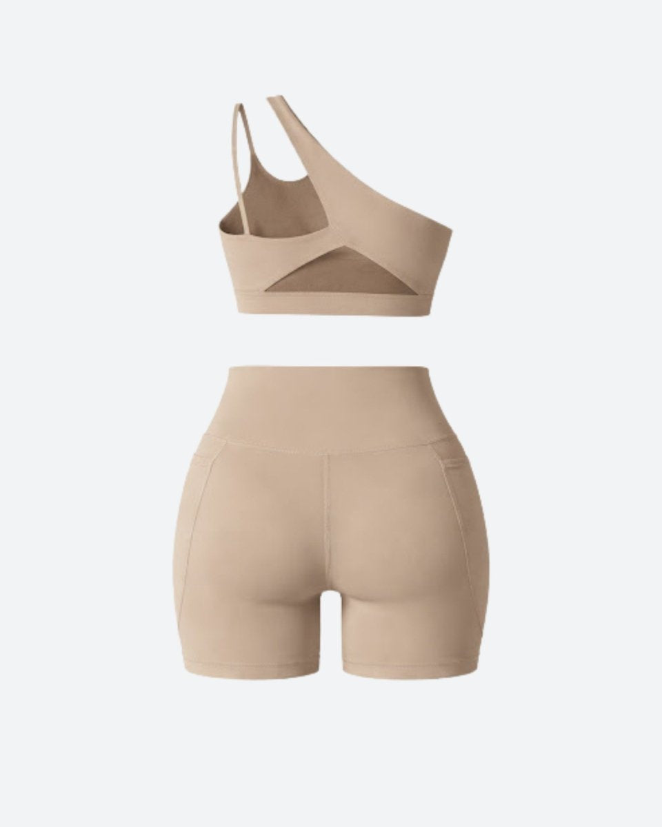 Flat lay back view of khaki luxury workout set showing rear sports bra cutout and back seam details of high rise shorts.