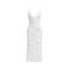 White kouvr dress with button details on a white background.