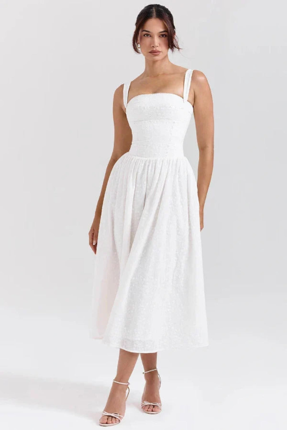 Model wearing Kouvr Apolline white corset midi dress with a square neckline and full A-line skirt
