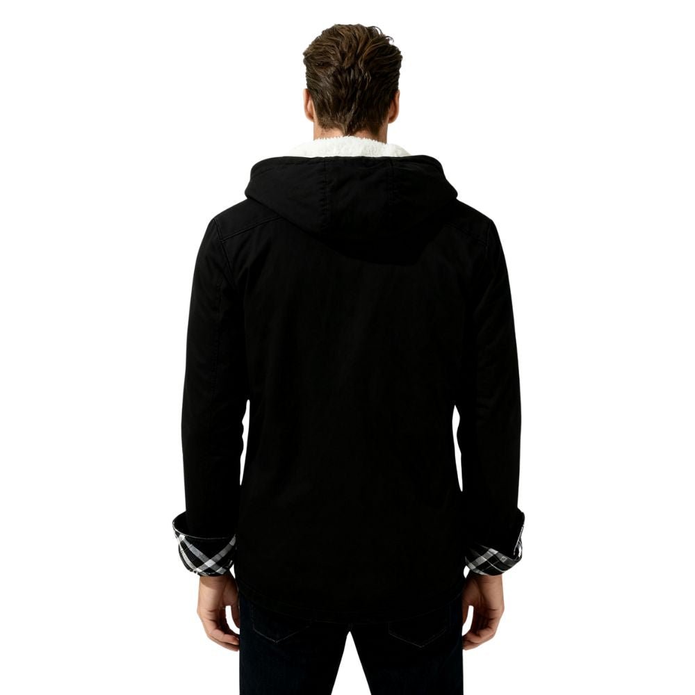 Person wearing a black kouvr jacket with plaid cuffs on a white background