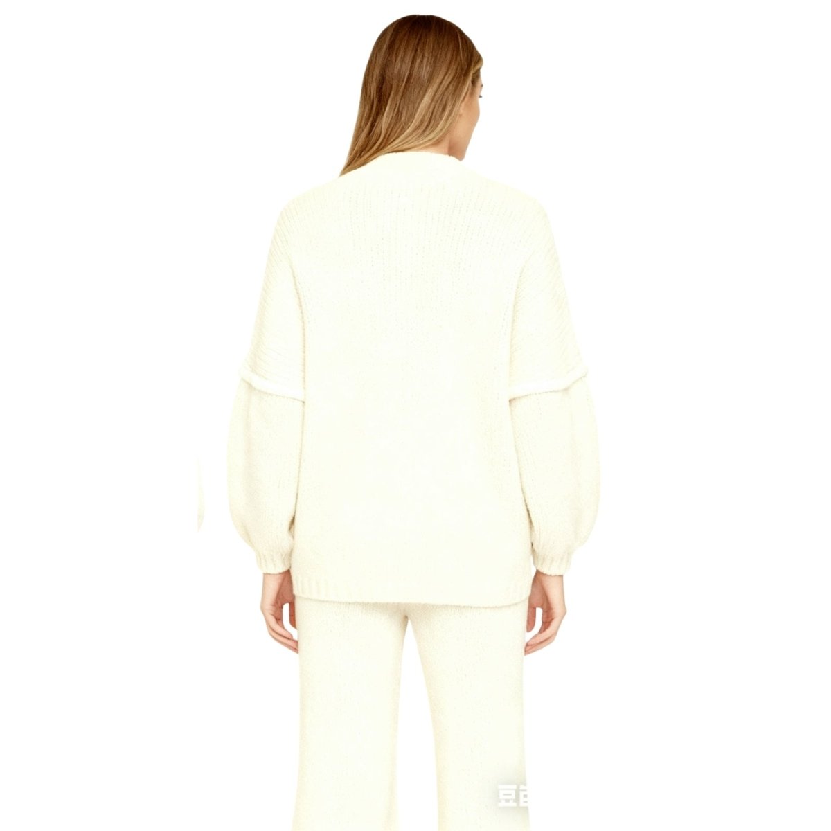 model wearing the Kouvr oversized chunky knit cardigan in cream, made from a luxurious alpaca and wool blend.