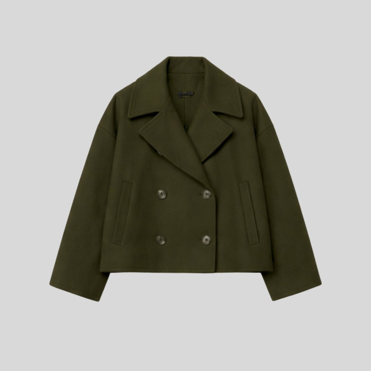 Product-only studio shot of the Kouvr double-breasted cropped wool peacoat in dark green , showing the button details and texture.