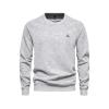 Studio product shot of the Kouvr Deacon Crewneck Sweatshirt in heather light grey, showing fabric texture and the embroidered logo in detail.