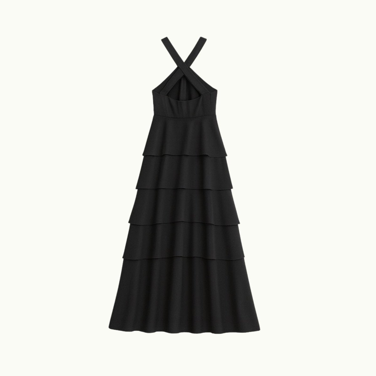 Black Kouvr tiered dress with criss-cross straps on a white background