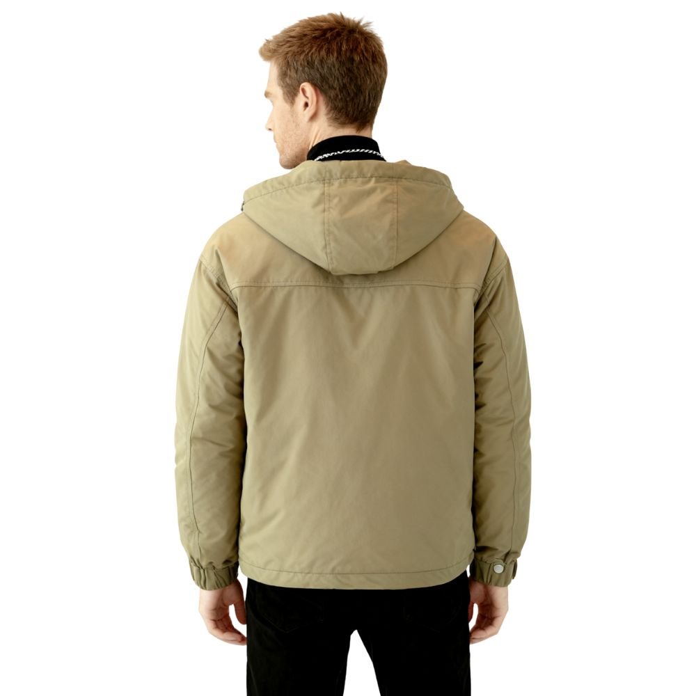 Man wearing the Kouvr Fashion Urbanite Technical Parka in Green over a black turtleneck
