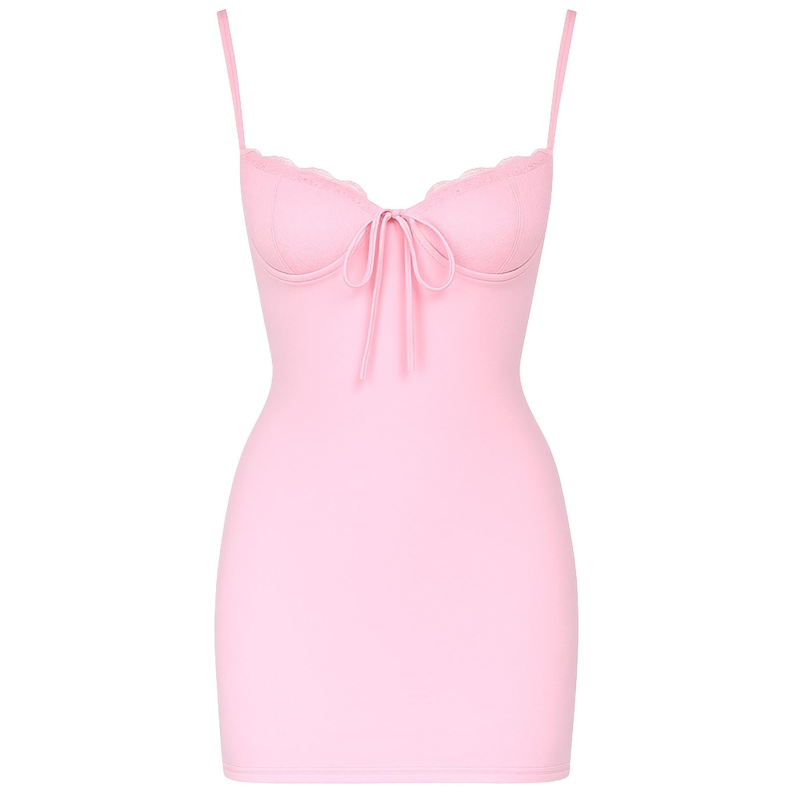 Woman wearing a pink kouvr dress on a white background