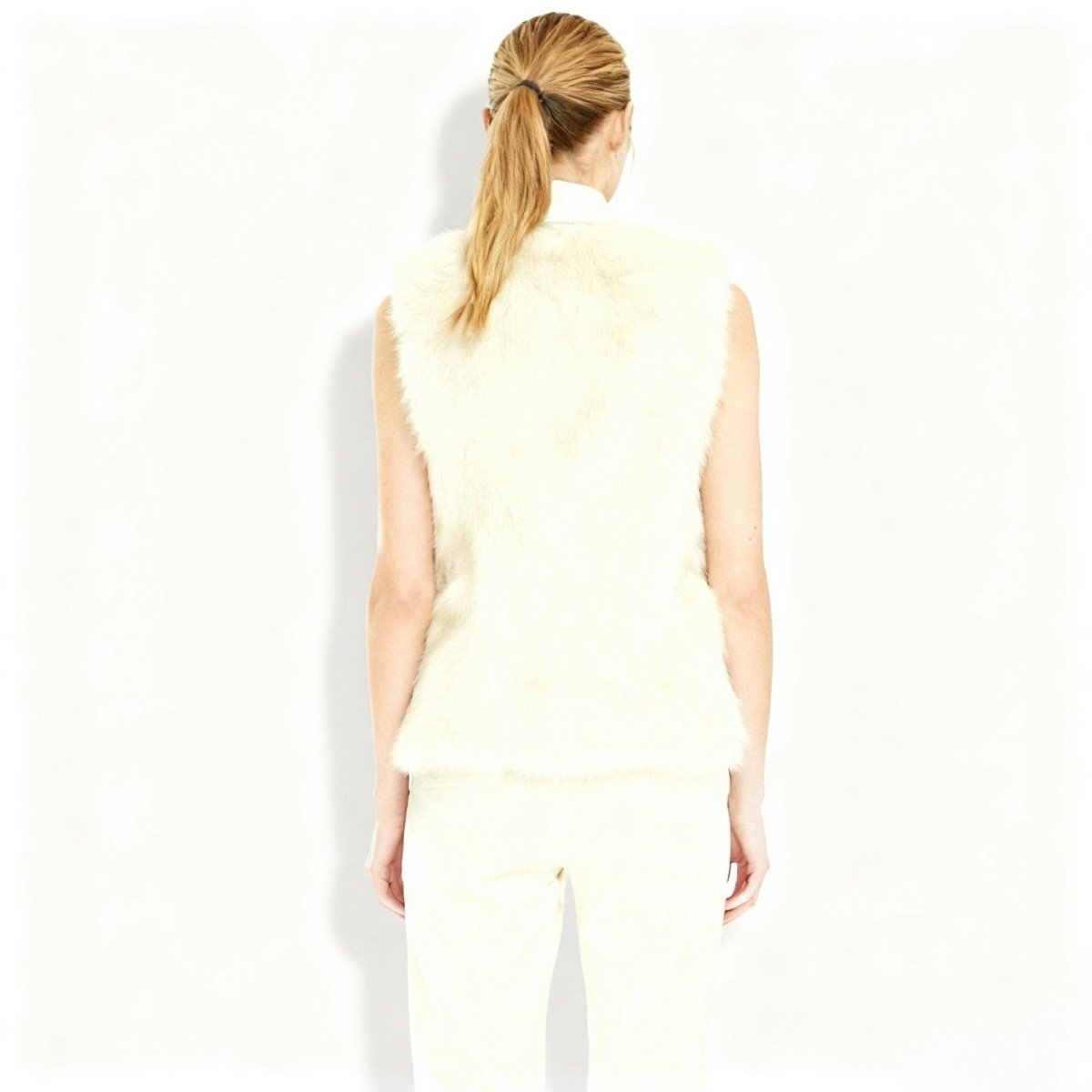 Woman wearing a Ivory Kouvr sleeveless top and pants on a white background