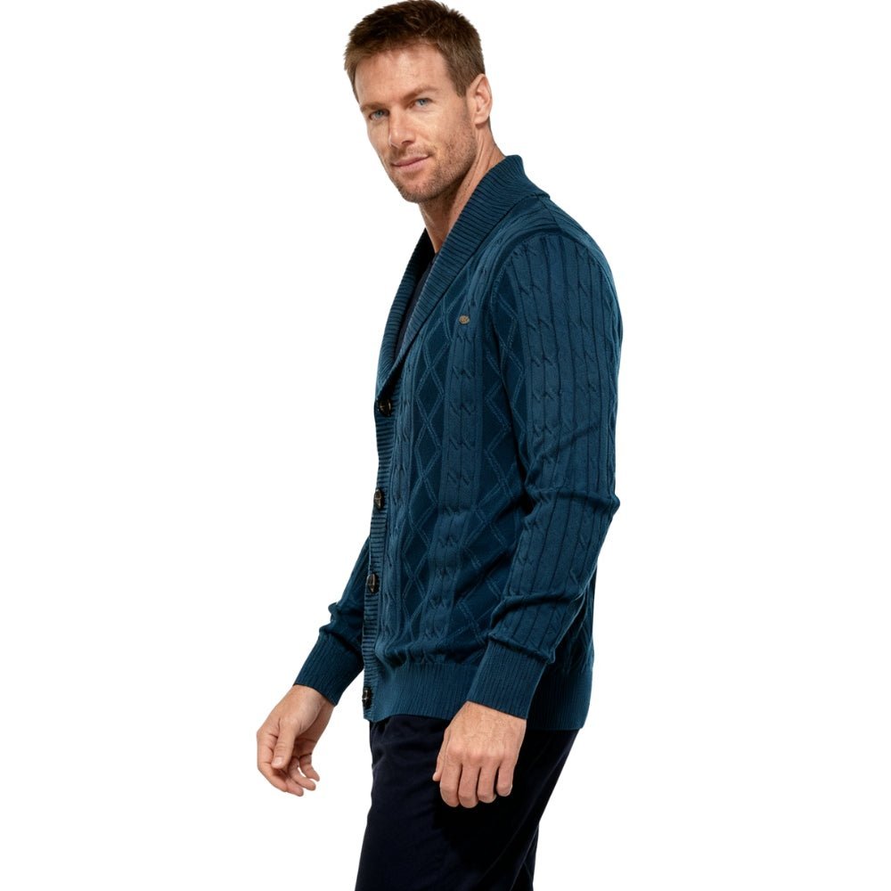 Man wearing a blue kouvr cable knit cardigan on a white background