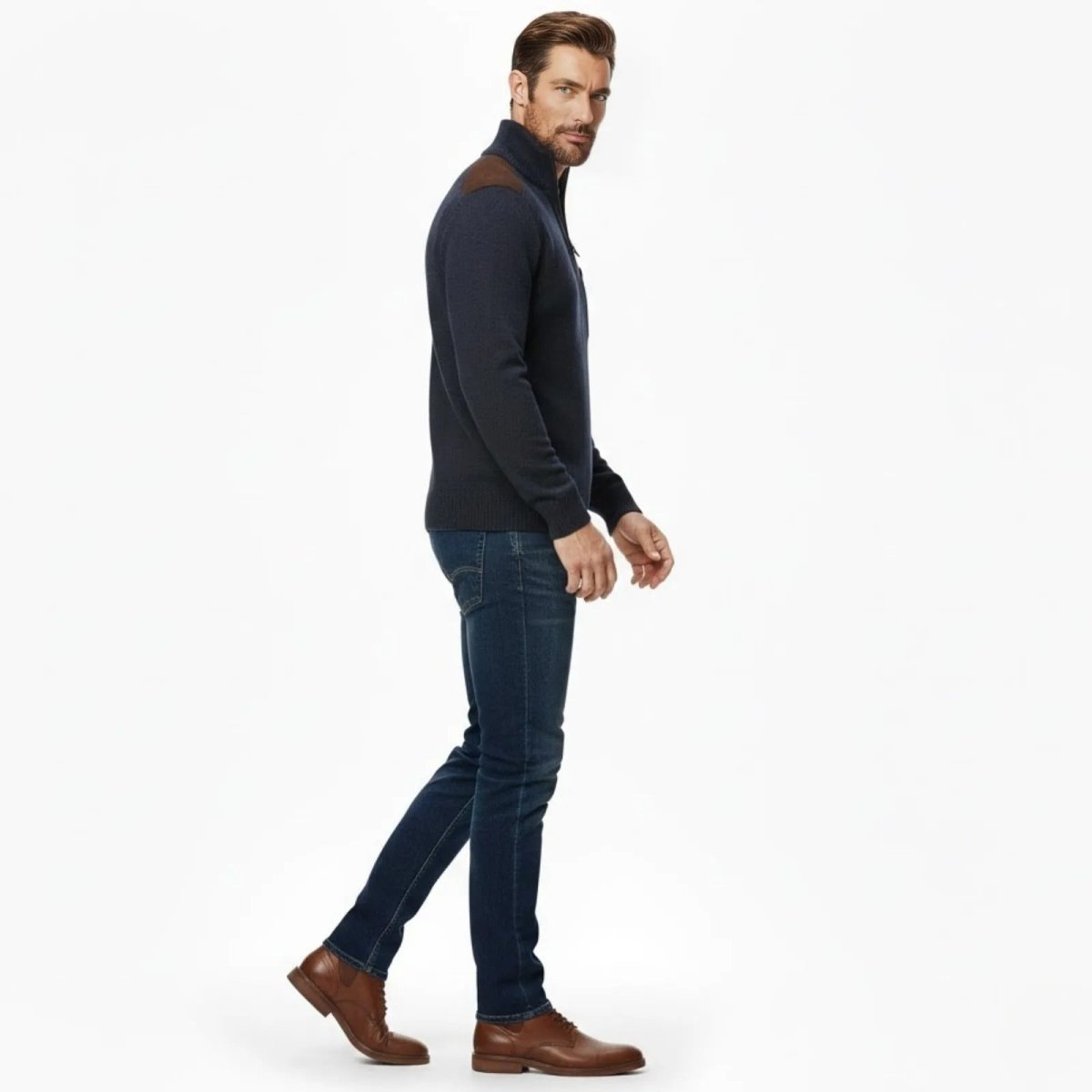 Side view of a male model walking while wearing the Kouvr Fashion navy blue knit half-zip pullover, showing the slim fit profile.